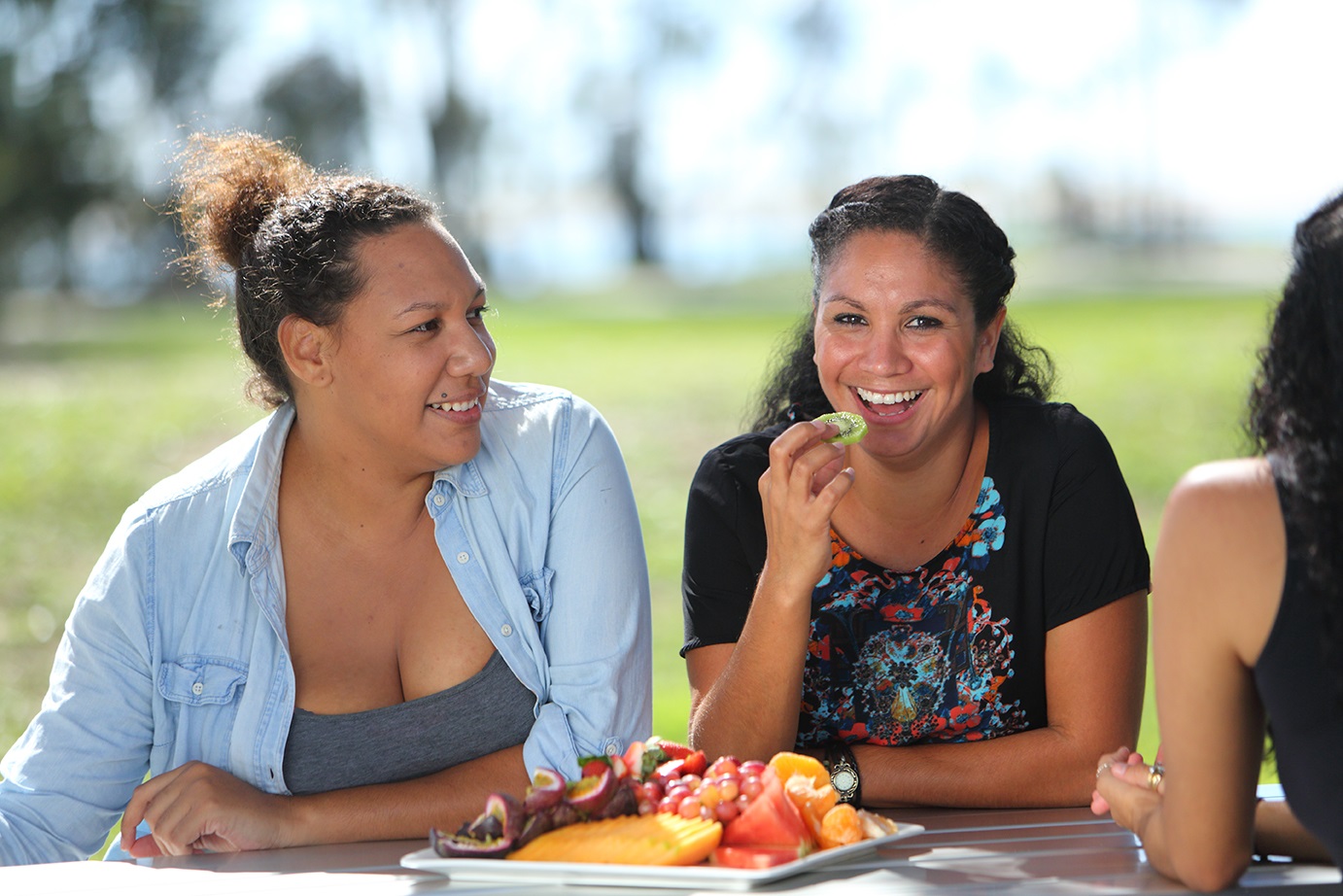 Indigenous women eating fruit
