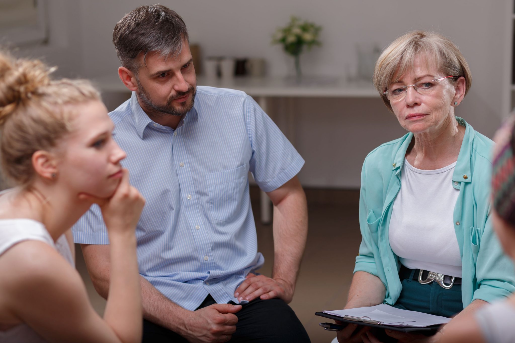 Psychologist in group therapy